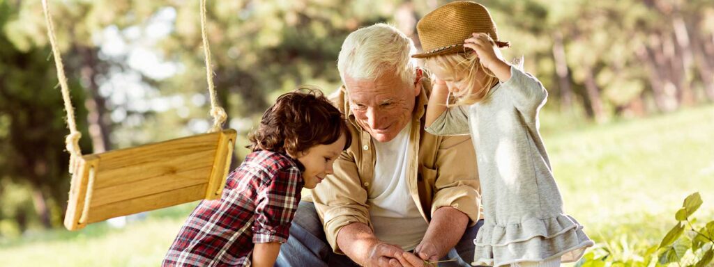 A grandfather playing with his children