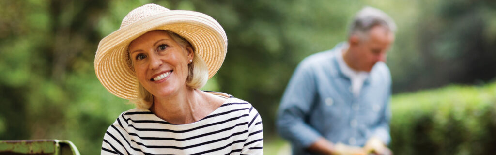 A woman and her husband gardening